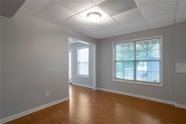 2157 Brandon Lee Dr SW, Marietta, GA 30008 - empty room with a paneled ceiling, plenty of natural light, wood finished floors, and baseboards
