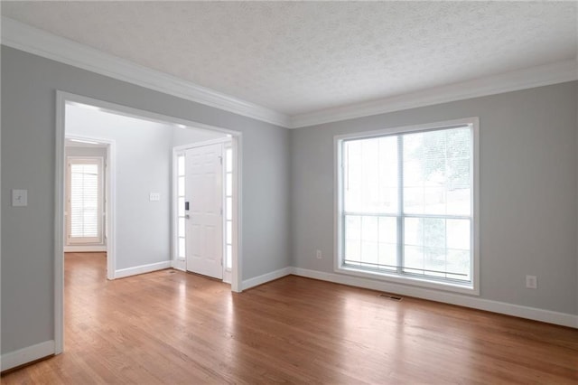 2157 Brandon Lee Dr SW, Marietta, GA 30008 - empty room with light wood-style flooring, a textured ceiling, plenty of natural light, crown molding, and baseboards
