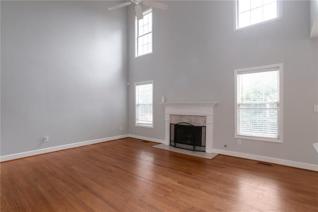 2157 Brandon Lee Dr SW, Marietta, GA 30008 - unfurnished living room with a towering ceiling, ceiling fan, baseboards, and wood finished floors