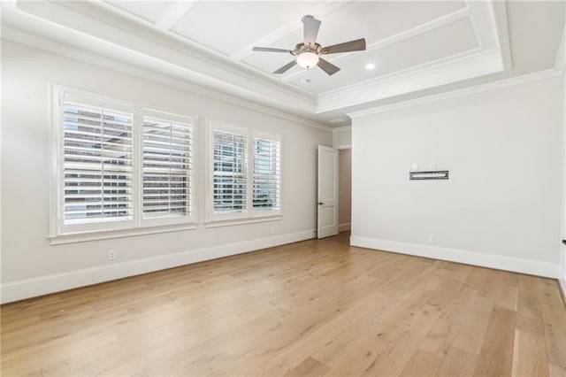 empty room featuring light wood-style floors, baseboards, and crown molding