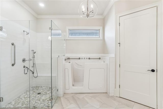 full bath with a garden tub, marble finish floor, an inviting chandelier, crown molding, and a shower stall