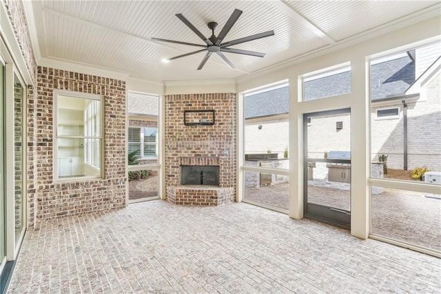 unfurnished sunroom with a healthy amount of sunlight and a ceiling fan