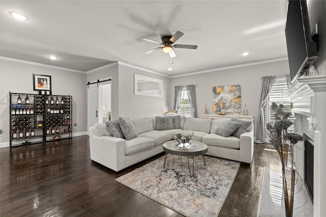 living room with wood finished floors, recessed lighting, ceiling fan, and a barn door