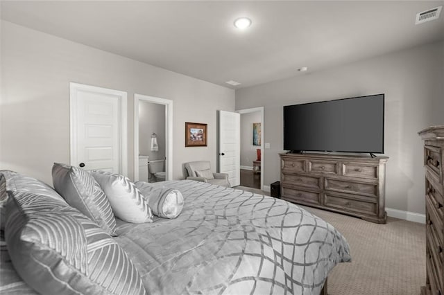 bedroom with carpet, visible vents, baseboards, and connected bathroom