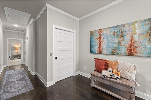 foyer featuring wood finished floors, baseboards, and ornamental molding