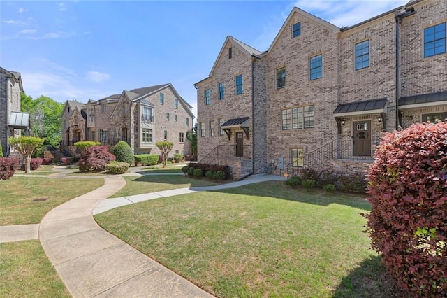 exterior space featuring a lawn and a residential view