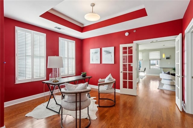 office area featuring french doors, crown molding, hardwood / wood-style flooring, and a tray ceiling