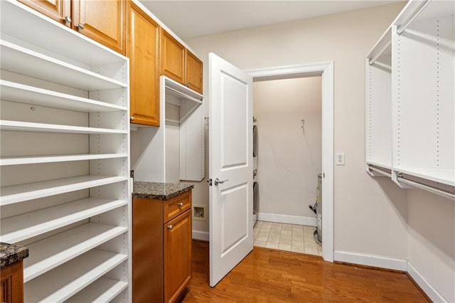 walk in closet featuring dark wood-type flooring