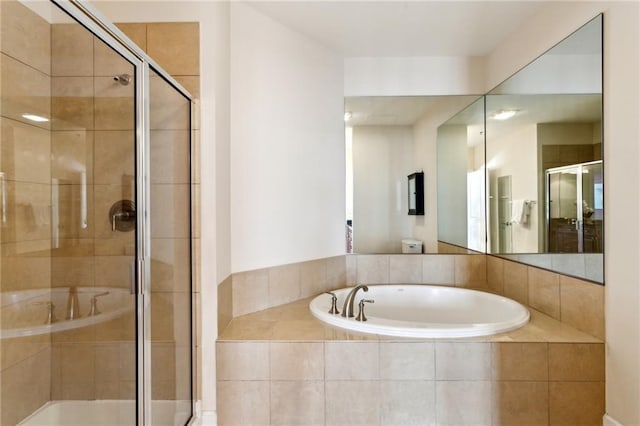 bathroom featuring shower with separate bathtub