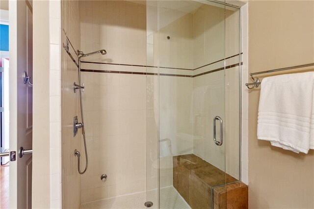 bathroom with a shower with door