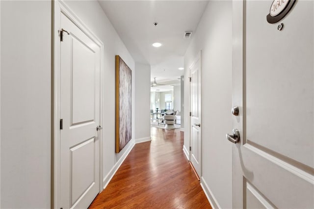 hall with wood-type flooring