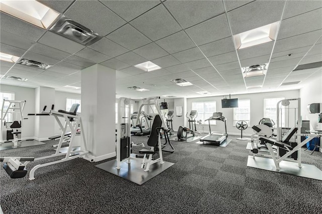 gym with a paneled ceiling