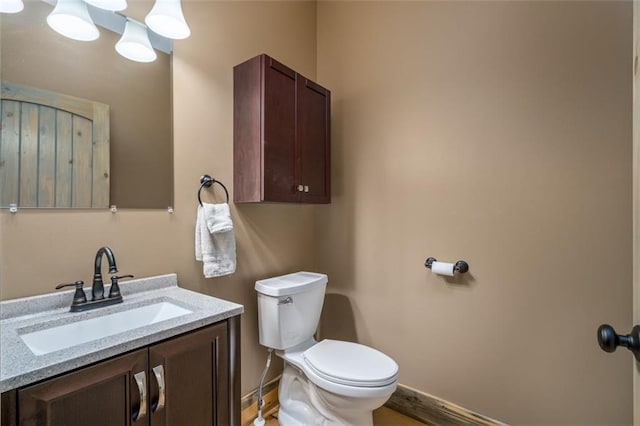 102 Waleska Ln, Ellijay, GA 30540 - half bathroom featuring toilet, baseboards, vanity, and wood finished floors