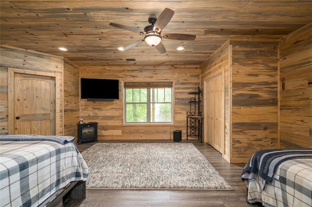 102 Waleska Ln, Ellijay, GA 30540 - bedroom with wood ceiling, wood walls, recessed lighting, a wood stove, and dark wood-type flooring