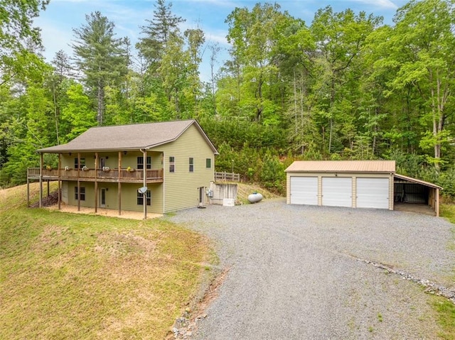 102 Waleska Ln, Ellijay, GA 30540 - view of front of property with an outdoor structure, a garage, a wooden deck, and a forest view