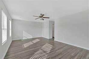 unfurnished living room with wood finished floors