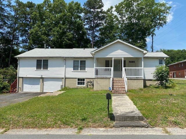 view of front of home with a front lawn, a garage, and a porch