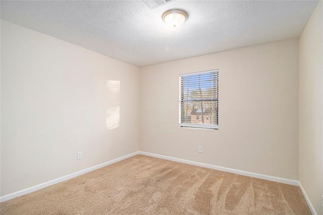 carpeted spare room featuring a textured ceiling