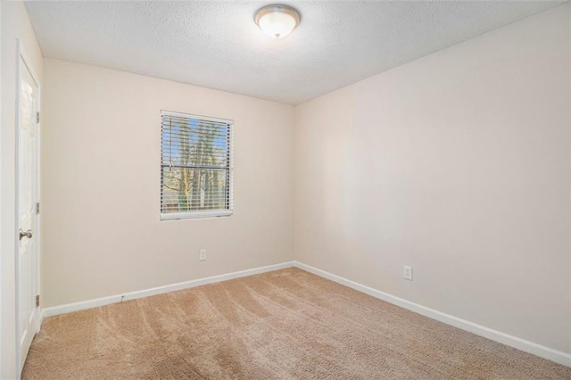 carpeted spare room featuring a textured ceiling