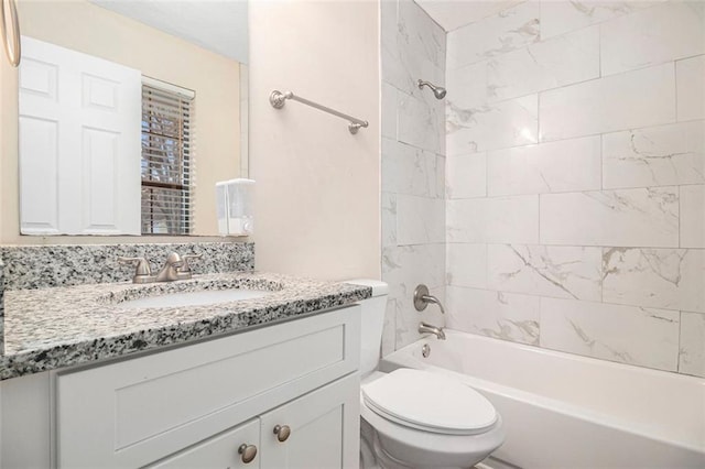 full bathroom with vanity, toilet, and tiled shower / bath