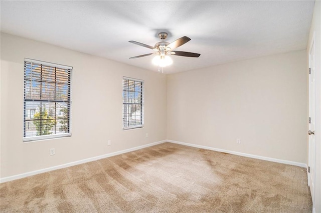 spare room featuring carpet flooring and ceiling fan