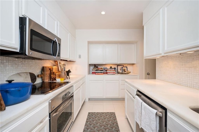 145 15th St NE Unit 1225, Atlanta, GA 30309 - kitchen featuring stainless steel appliances, backsplash, light countertops, white cabinets, and recessed lighting