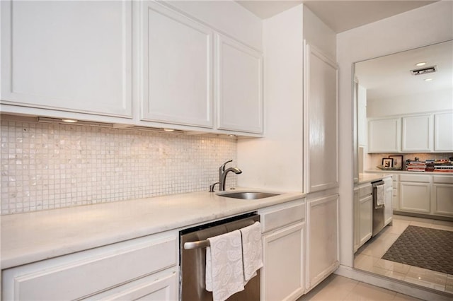 145 15th St NE Unit 1225, Atlanta, GA 30309 - kitchen with a sink, stainless steel dishwasher, light countertops, light tile patterned floors, and backsplash