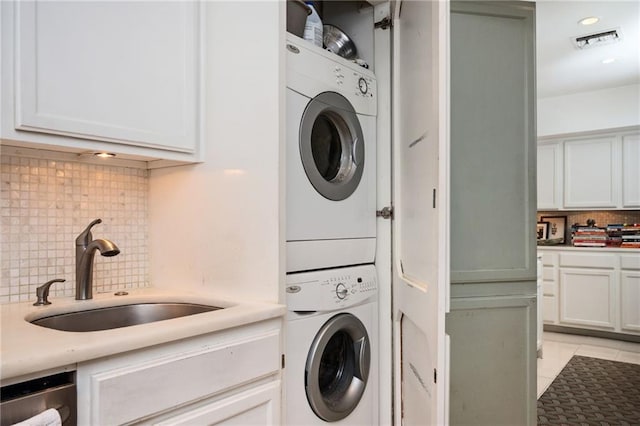 145 15th St NE Unit 1225, Atlanta, GA 30309 - laundry area featuring stacked washer / dryer, light tile patterned floors, and recessed lighting