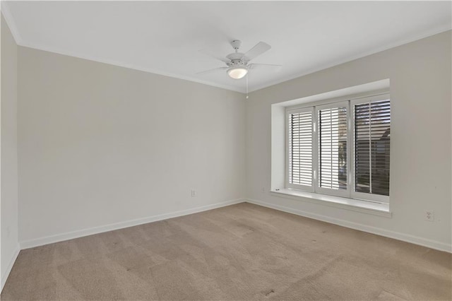 spare room with ornamental molding, light colored carpet, and ceiling fan