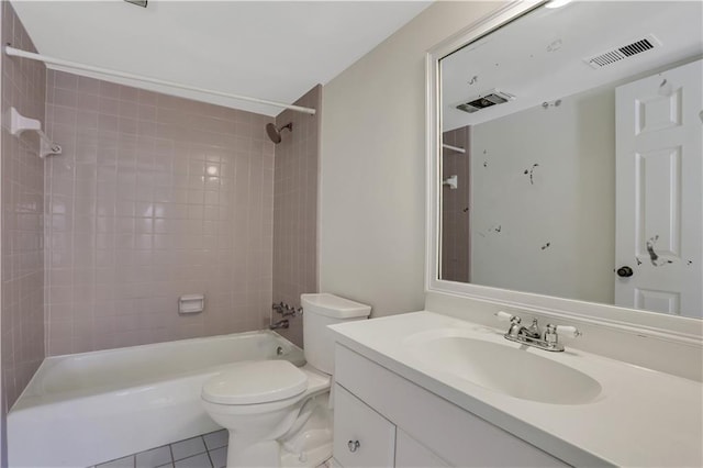 full bathroom with vanity, tile patterned flooring, tiled shower / bath combo, and toilet