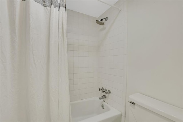 bathroom featuring shower / bath combo and toilet