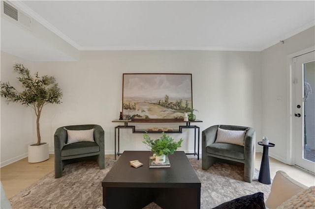 sitting room featuring crown molding and wood-type flooring