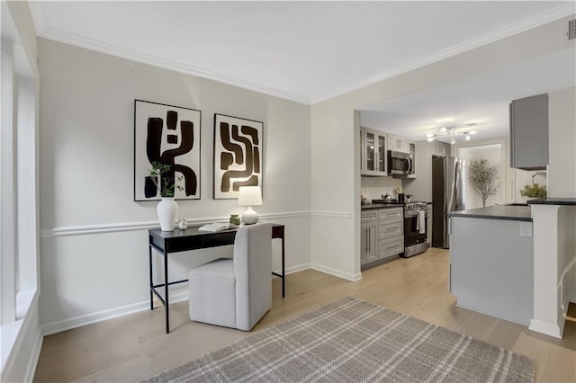 interior space featuring light hardwood / wood-style flooring, ornamental molding, gray cabinets, kitchen peninsula, and stainless steel appliances