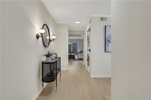 corridor with crown molding and light hardwood / wood-style flooring