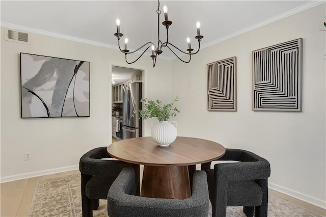 dining room with crown molding and light wood-type flooring