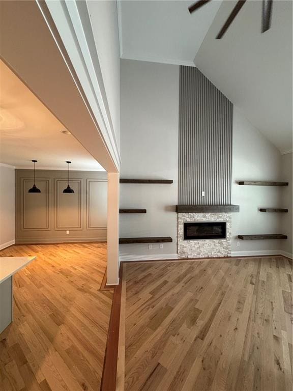 1713 Cagle Ct, Lawrenceville, GA 30045 - unfurnished living room with light wood finished floors, ceiling fan, a fireplace, high vaulted ceiling, and baseboards