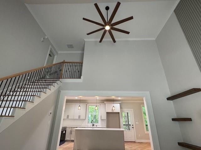 1713 Cagle Ct, Lawrenceville, GA 30045 - stairway with ceiling fan, a high ceiling, wood finished floors, ornamental molding, and baseboards
