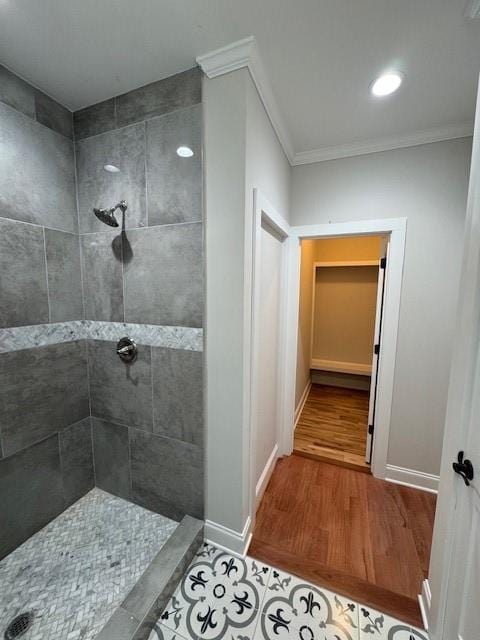 1713 Cagle Ct, Lawrenceville, GA 30045 - full bathroom with a tile shower, wood finished floors, ornamental molding, and baseboards