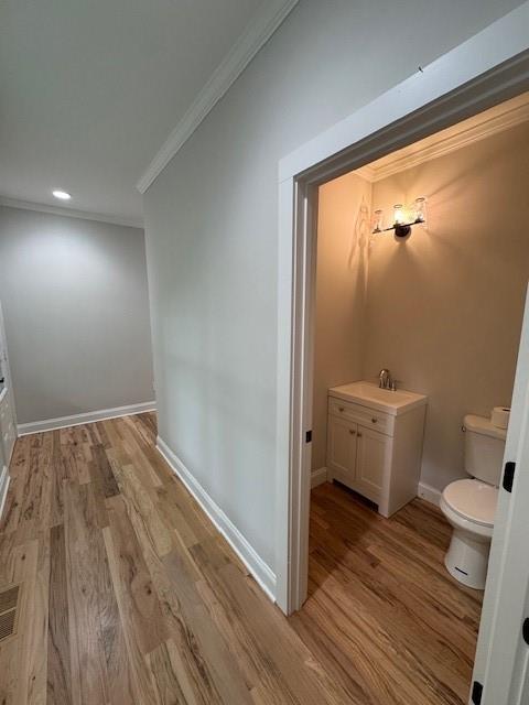1713 Cagle Ct, Lawrenceville, GA 30045 - corridor with crown molding, light wood finished floors, baseboards, and recessed lighting