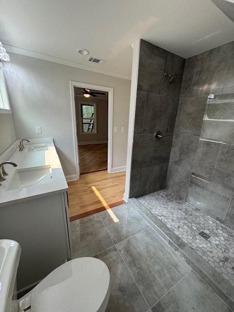 1713 Cagle Ct, Lawrenceville, GA 30045 - full bathroom with crown molding, toilet, healthy amount of natural light, tiled shower, and double vanity