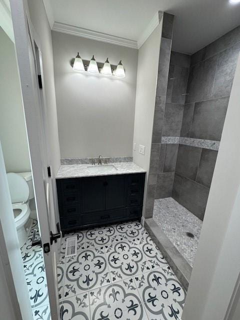 1713 Cagle Ct, Lawrenceville, GA 30045 - bathroom with toilet, ornamental molding, tiled shower, vanity, and tile patterned floors