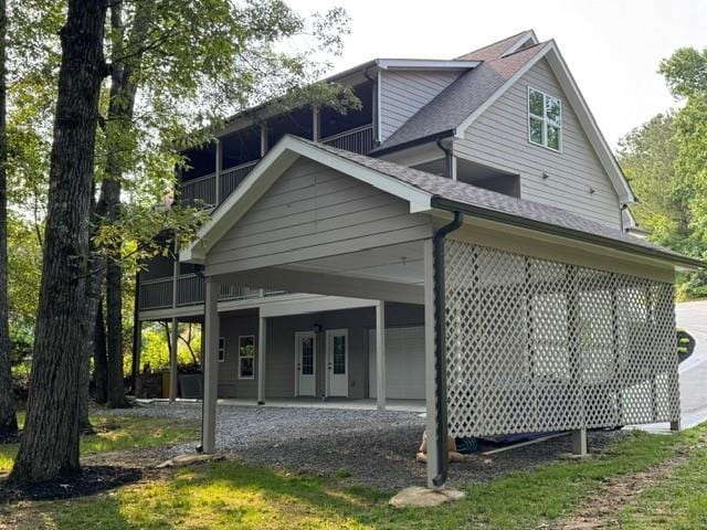 1713 Cagle Ct, Lawrenceville, GA 30045 - rear view of house featuring driveway, an attached carport, and a shingled roof