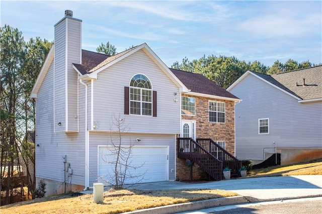 rear view of property featuring a garage