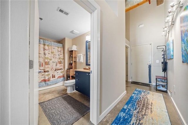 bathroom with vanity, toilet, and a shower with shower curtain