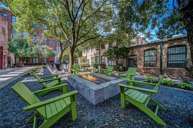 view of community featuring a patio and an outdoor fire pit