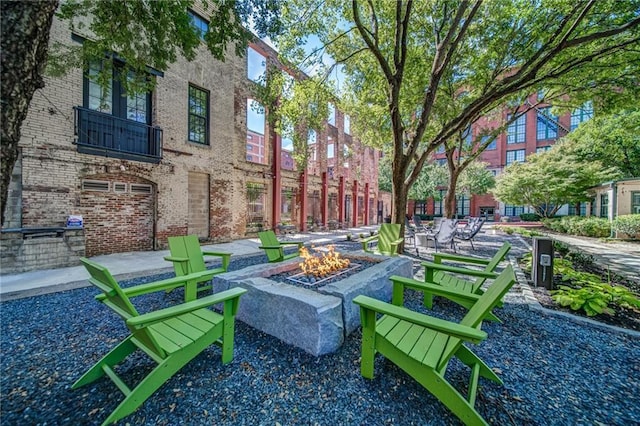 view of community featuring a patio area and an outdoor fire pit