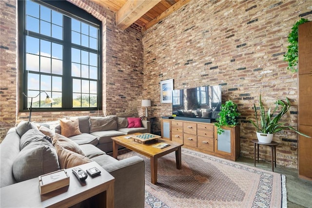 living room featuring beamed ceiling, a high ceiling, and wooden ceiling