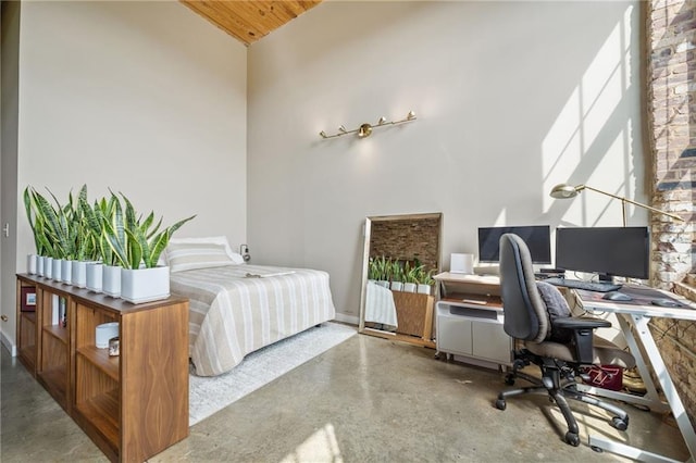 bedroom featuring a towering ceiling and concrete flooring