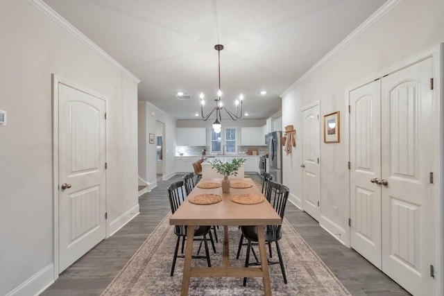 dining space featuring ornamental molding and dark hardwood / wood-style floors