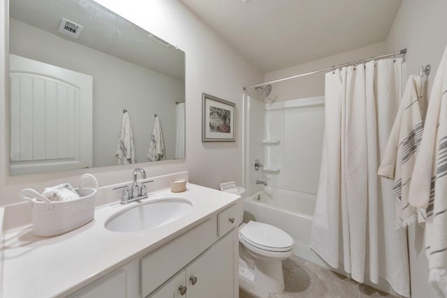 full bathroom with vanity, shower / tub combo, and toilet